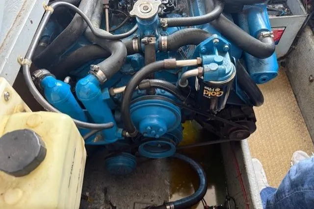 Slide: The Image of Engine of a 1993 Silverton 34 Convertible boat, featuring blue components and hoses. - 56