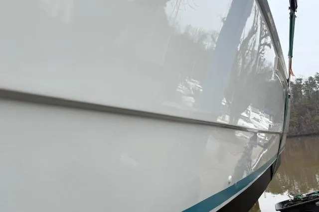 Slide: The Image of 1993 Silverton 34 Convertible boat hull, reflecting water and trees. - 6