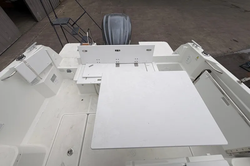 Slide: The Image of 2026 Jeanneau NC Weekender 795 Series 2 boat deck with table and seating area. - 11