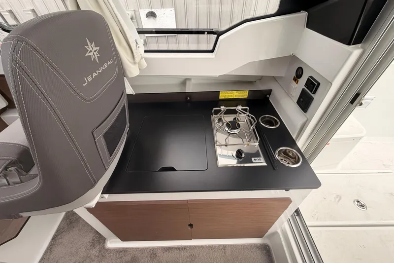 Slide: The Image of Interior of 2026 Jeanneau NC Weekender 795 Series 2 with compact kitchen setup. - 12