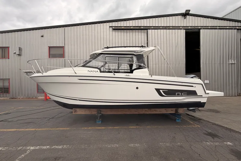 Slide: The Image of 2026 Jeanneau NC Weekender 795 Series 2 boat on display outside a warehouse. - 3
