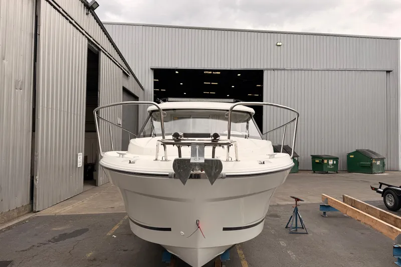 Slide: The Image of 2026 Jeanneau NC Weekender 795 Series 2 boat in front of a warehouse. - 4