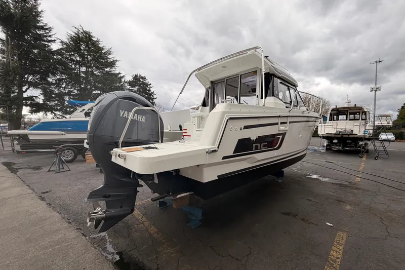 Slide: The Image of 2026 Jeanneau NC Weekender 795 Series 2 boat with Yamaha engine, docked outdoors. - 6