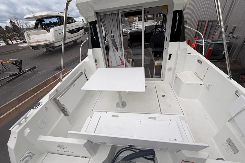 Slide: The Image of 2026 Jeanneau NC Weekender 795 Series 2 boat interior with table and seating area. - 9