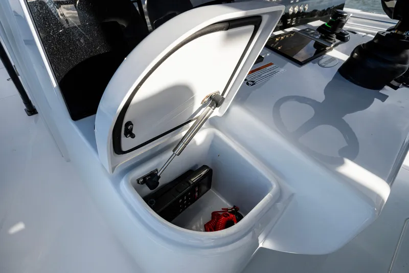 Slide: The Image of Open storage compartment on 2024 Contender 44 ST boat console. - 12