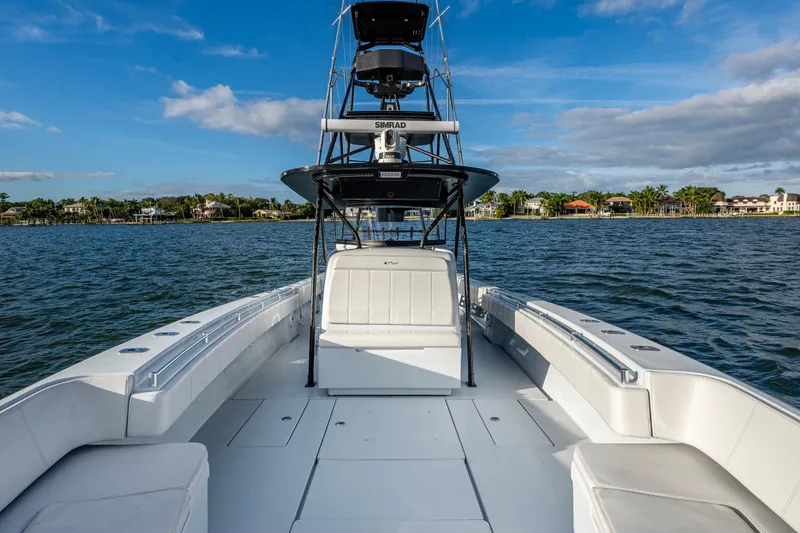 Slide: The Image of 2024 Contender 44 ST boat on water, showcasing spacious deck and sleek design. - 13