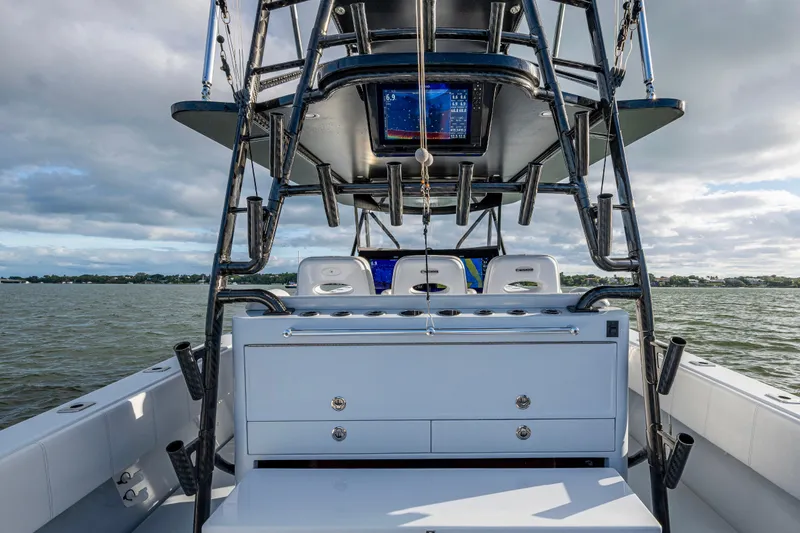 Slide: The Image of 2024 Contender 44 ST boat interior with advanced navigation system on open water. - 25