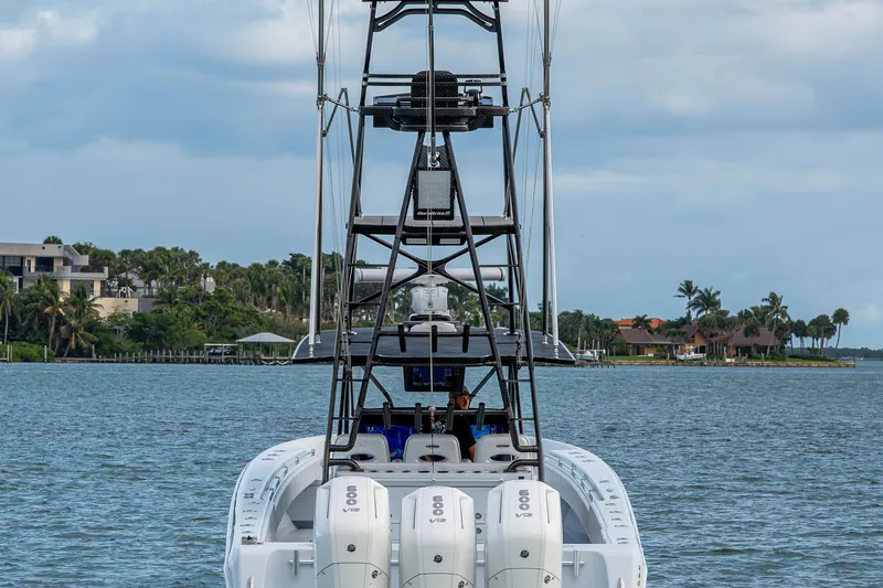 Slide: The Image of 2024 Contender 44 ST boat with triple engines on a scenic waterway. - 27