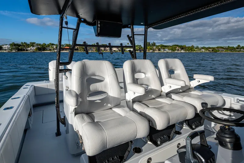 Slide: The Image of 2024 Contender 44 ST boat interior with luxurious white seating and ocean backdrop. - 7