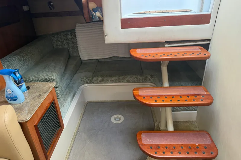 Slide: The Image of Interior of 2008 Cruisers Yachts 330 Express with wooden steps and cozy seating area. - 15