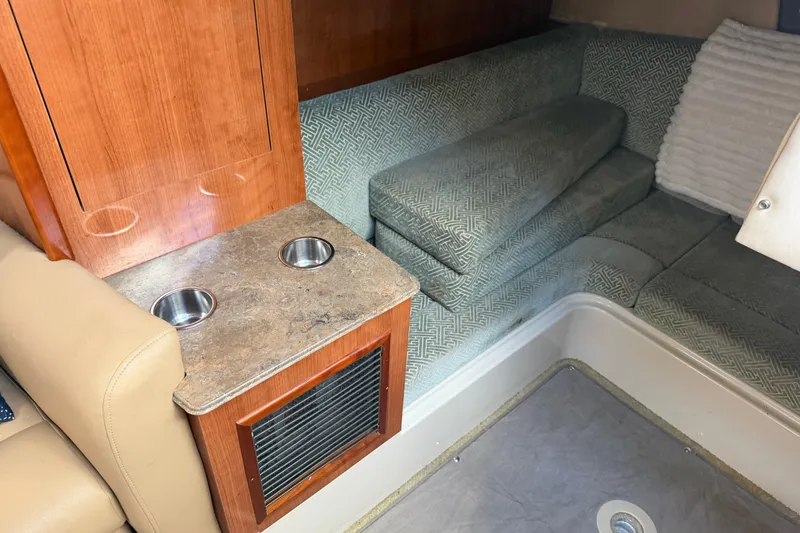 Slide: The Image of 2008 Cruisers Yachts 330 Express interior with cozy seating and wooden cabinetry. - 16