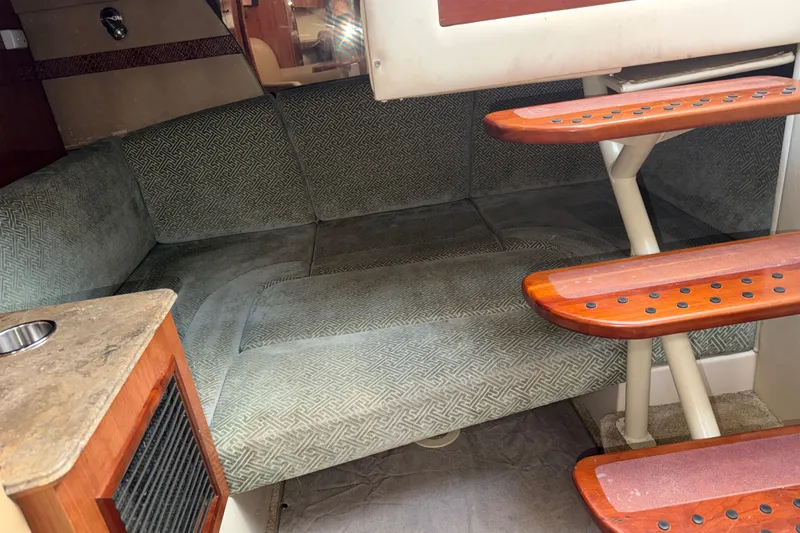 Slide: The Image of 2008 Cruisers Yachts 330 Express interior with cushioned seating and wooden steps. - 18