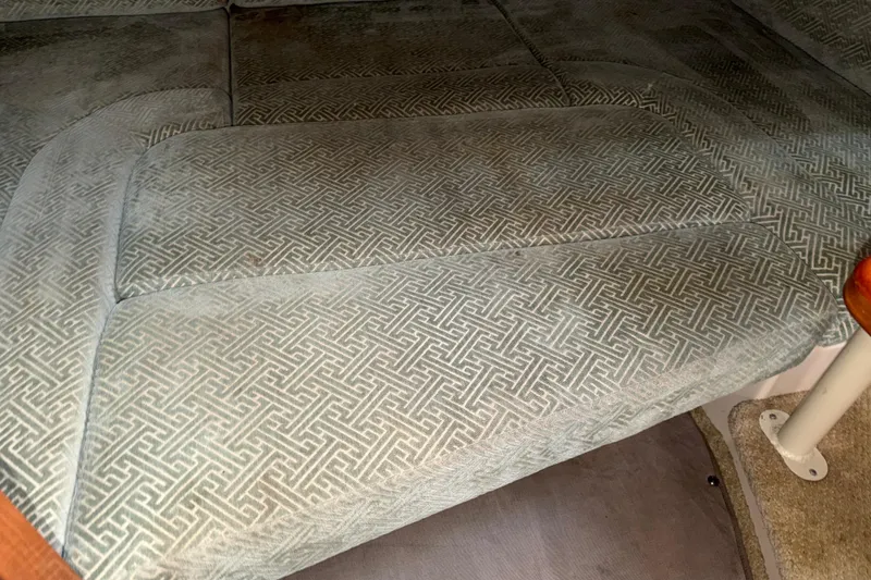 Slide: The Image of 2008 Cruisers Yachts 330 Express interior with patterned upholstery and carpeted flooring. - 19