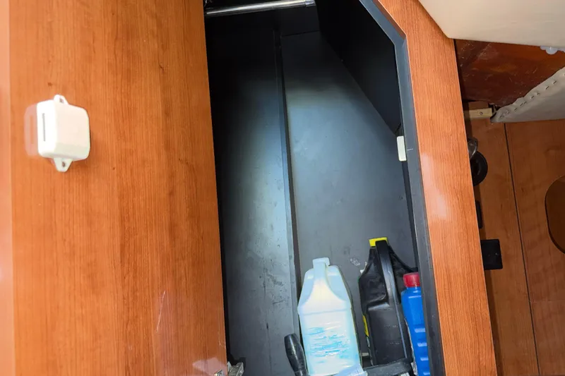 Slide: The Image of Storage compartment on 2008 Cruisers Yachts 330 Express with cleaning supplies. - 24