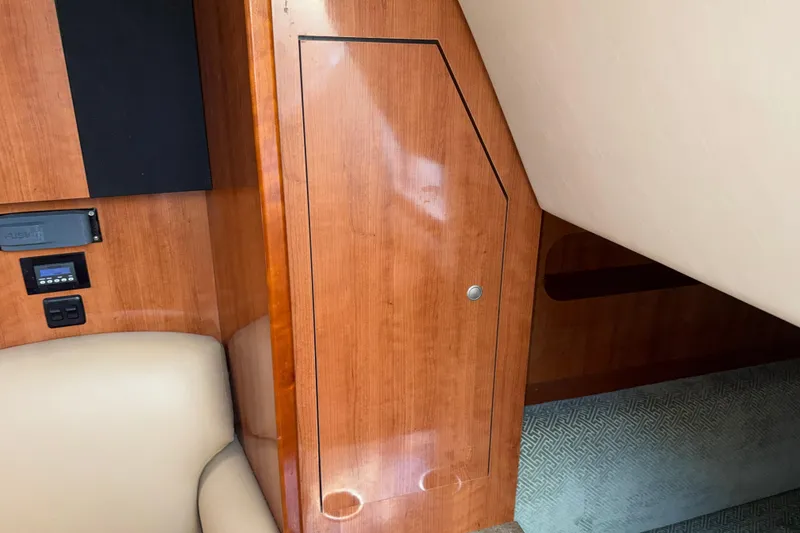 Slide: The Image of Interior of 2008 Cruisers Yachts 330 Express, featuring wood paneling and seating. - 25