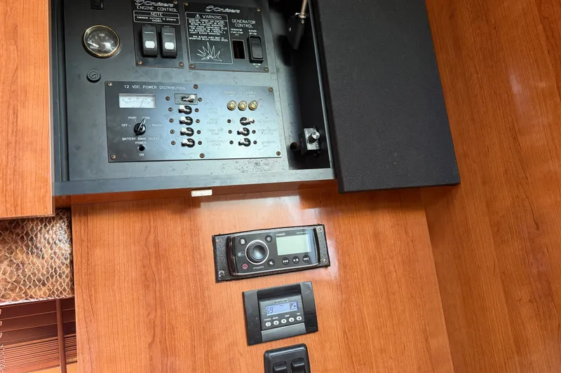 Slide: The Image of 2008 Cruisers Yachts 330 Express control panel with wood finish and electronic controls. - 26