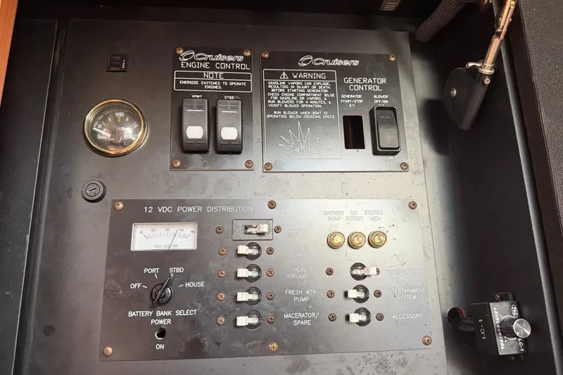 Slide: The Image of Control panel of a 2008 Cruisers Yachts 330 Express, featuring engine and power distribution controls. - 27