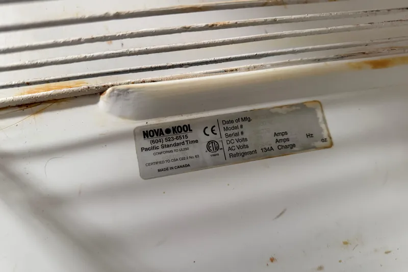 Slide: The Image of Label on Nova Kool refrigerator in 2008 Cruisers Yachts 330 Express, showing specifications and contact details. - 28