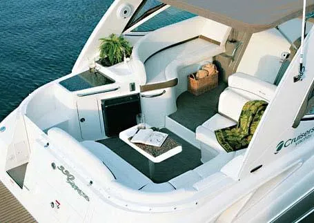 Slide: The Image of 2008 Cruisers Yachts 330 Express cabin with cozy bed and decorative pillows. - 3
