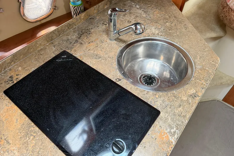 Slide: The Image of 2008 Cruisers Yachts 330 Express kitchen with sink and stovetop. - 31