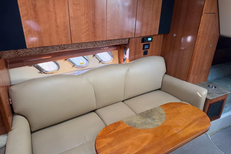 Slide: The Image of 2008 Cruisers Yachts 330 Express interior with beige sofa and wooden cabinetry. - 34