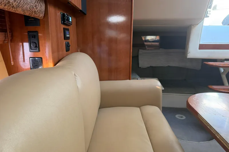 Slide: The Image of 2008 Cruisers Yachts 330 Express interior with beige seating and wooden accents. - 38