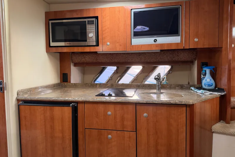Slide: The Image of 2008 Cruisers Yachts 330 Express kitchen with microwave, sink, and countertop. - 39