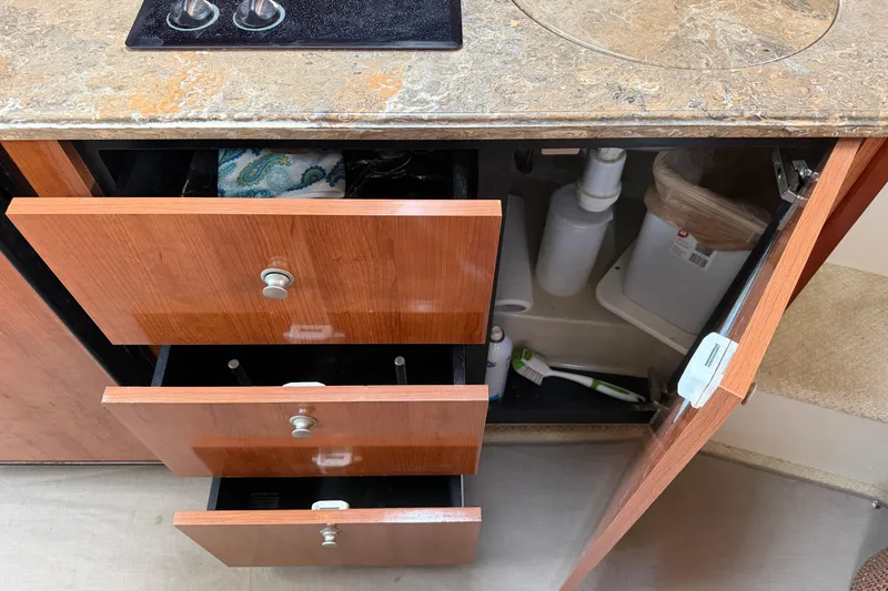 Slide: The Image of 2008 Cruisers Yachts 330 Express kitchen with open drawers and cabinet. - 40