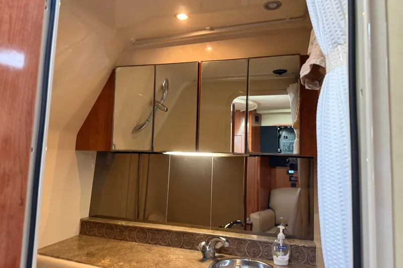 Slide: The Image of 2008 Cruisers Yachts 330 Express bathroom with mirrored cabinets and sink. - 46
