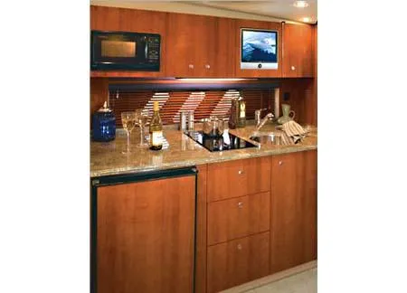 Slide: The Image of 2008 Cruisers Yachts 330 Express cabin interior with pillows and skylight. - 5