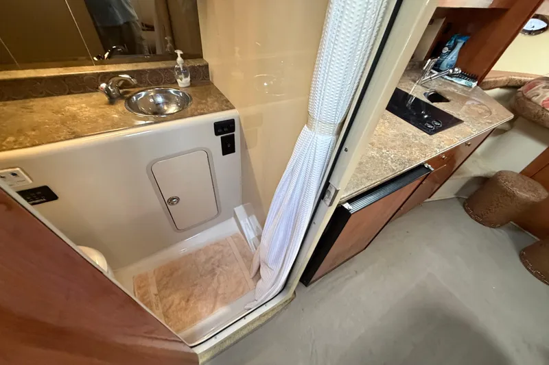 Slide: The Image of 2008 Cruisers Yachts 330 Express bathroom and kitchenette with sink and countertop. - 50