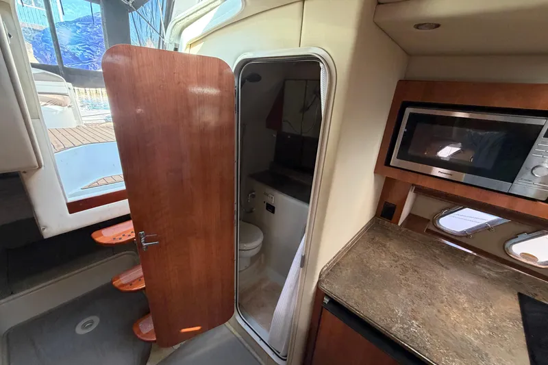 Slide: The Image of 2008 Cruisers Yachts 330 Express interior with kitchenette and bathroom. - 51