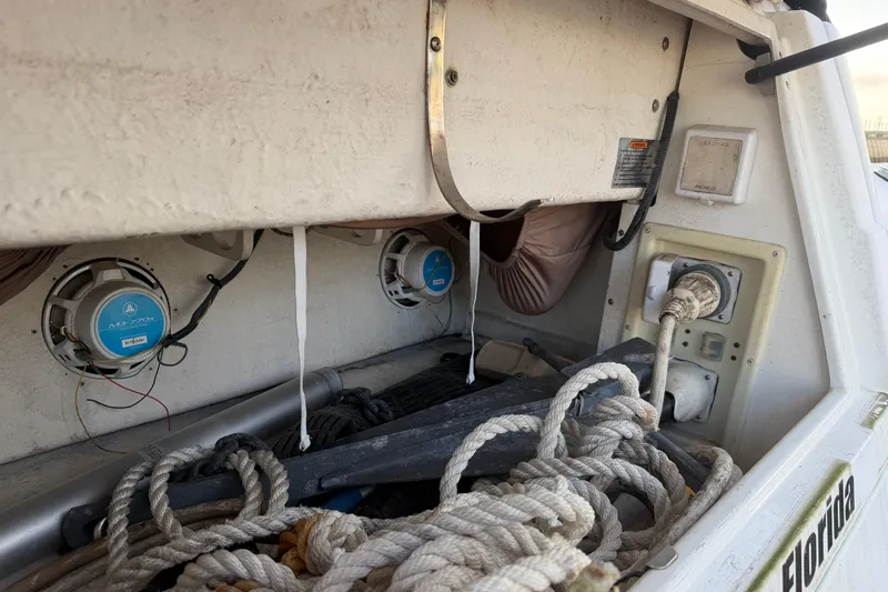 Slide: The Image of 2008 Cruisers Yachts 330 Express boat storage area with ropes and speakers. - 54