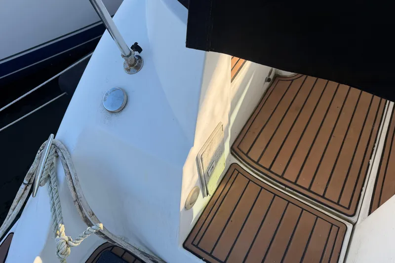 Slide: The Image of 2008 Cruisers Yachts 330 Express deck with wood-style flooring and mooring ropes. - 55