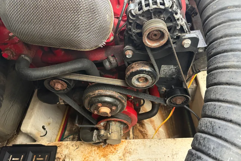 Slide: The Image of Engine components of a 2008 Cruisers Yachts 330 Express, showing belts and pulleys. - 56