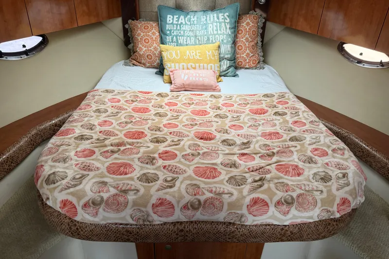 Slide: The Image of Cozy cabin interior of 2008 Cruisers Yachts 330 Express with seashell-themed bedding. - 59