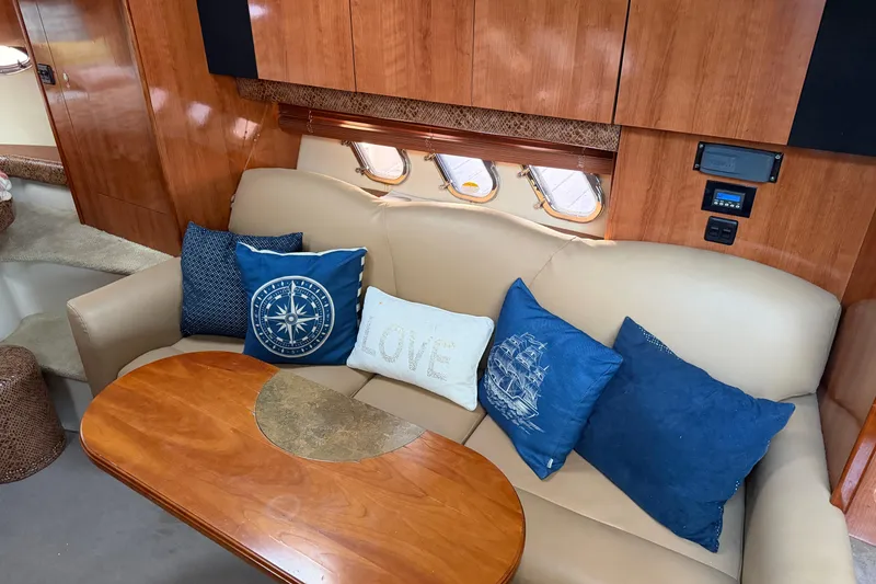 Slide: The Image of Interior of 2008 Cruisers Yachts 330 Express with cozy seating and nautical-themed pillows. - 62