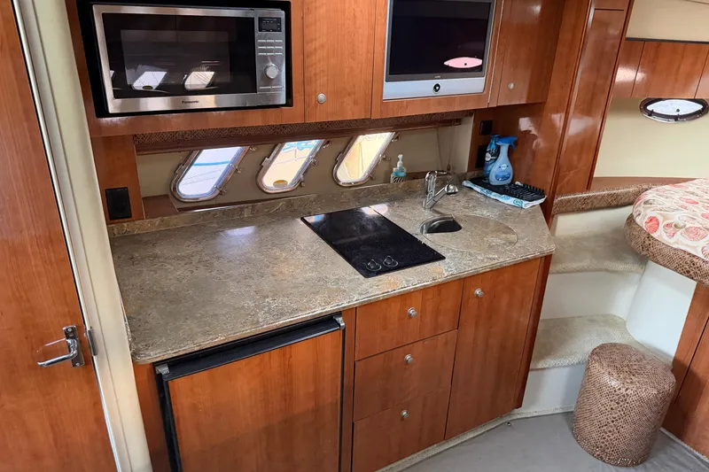 Slide: The Image of 2008 Cruisers Yachts 330 Express kitchen with microwave, stove, and sink. - 63