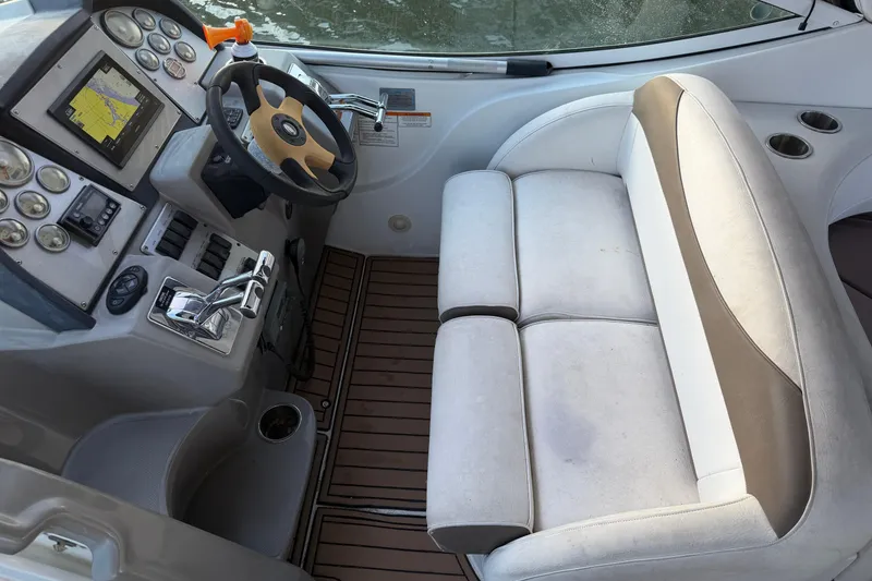 Slide: The Image of 2008 Cruisers Yachts 330 Express helm with steering wheel and navigation controls. - 66