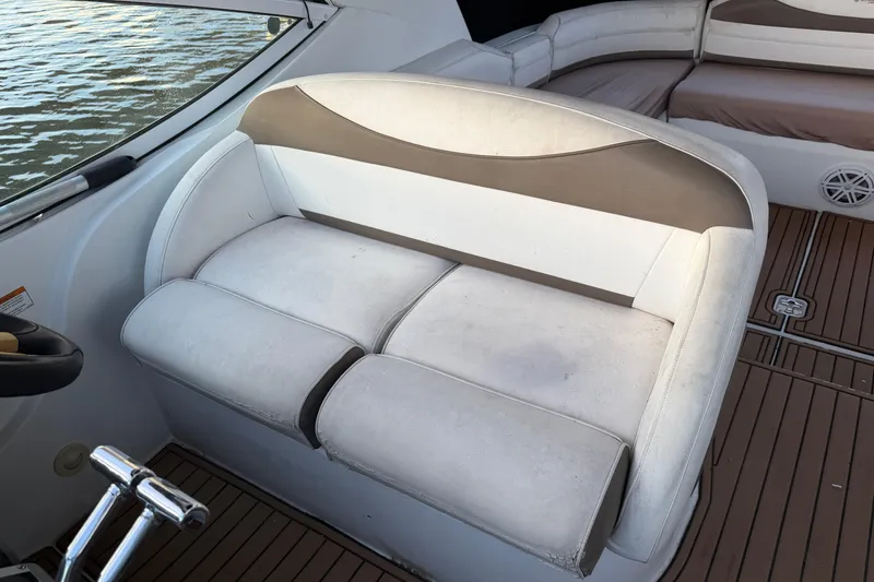 Slide: The Image of 2008 Cruisers Yachts 330 Express interior seating with white and beige upholstery. - 67