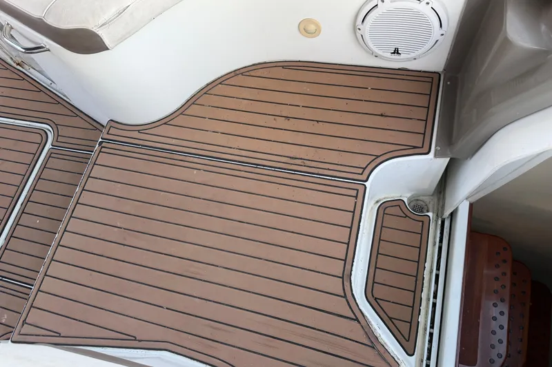 Slide: The Image of 2008 Cruisers Yachts 330 Express deck with brown marine flooring and speaker. - 69