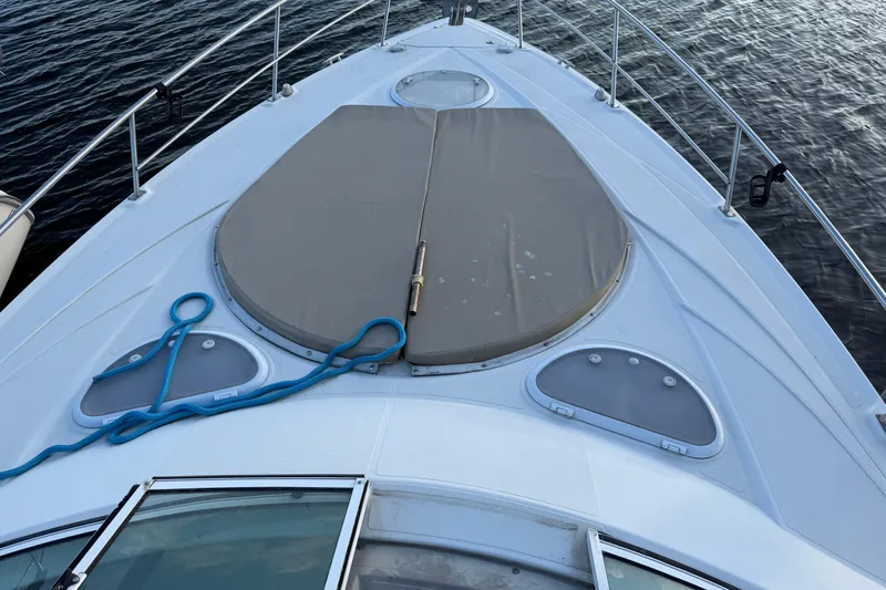 Slide: The Image of 2008 Cruisers Yachts 330 Express boat deck with blue rope and hatch cover. - 72