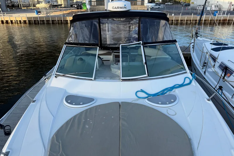 Slide: The Image of 2008 Cruisers Yachts 330 Express docked, featuring Garmin equipment and sleek design. - 74