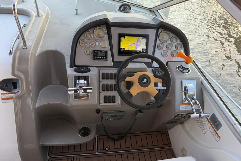 Slide: The Image of 2008 Cruisers Yachts 330 Express helm with navigation system and controls. - 76