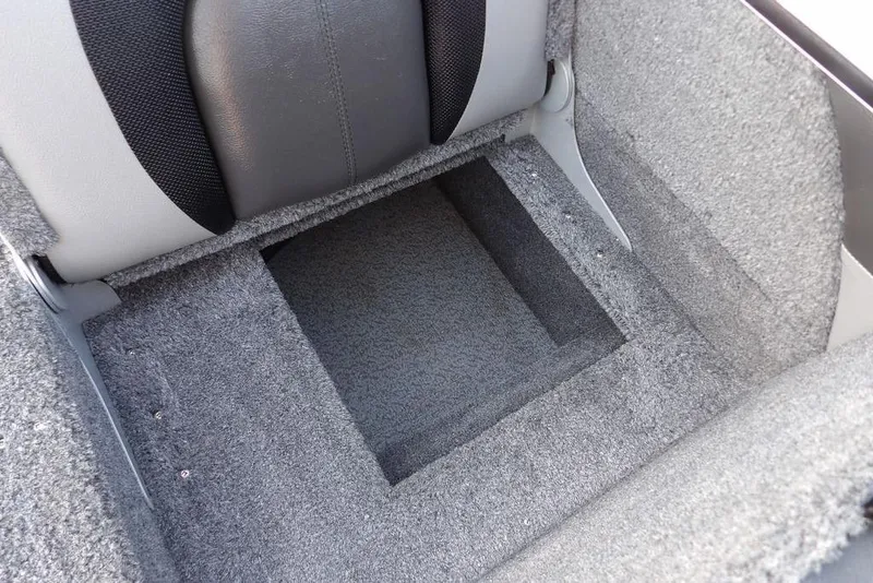 Slide: The Image of 2025 Lund 1875 Crossover XS boat interior storage compartment with gray carpet. - 11