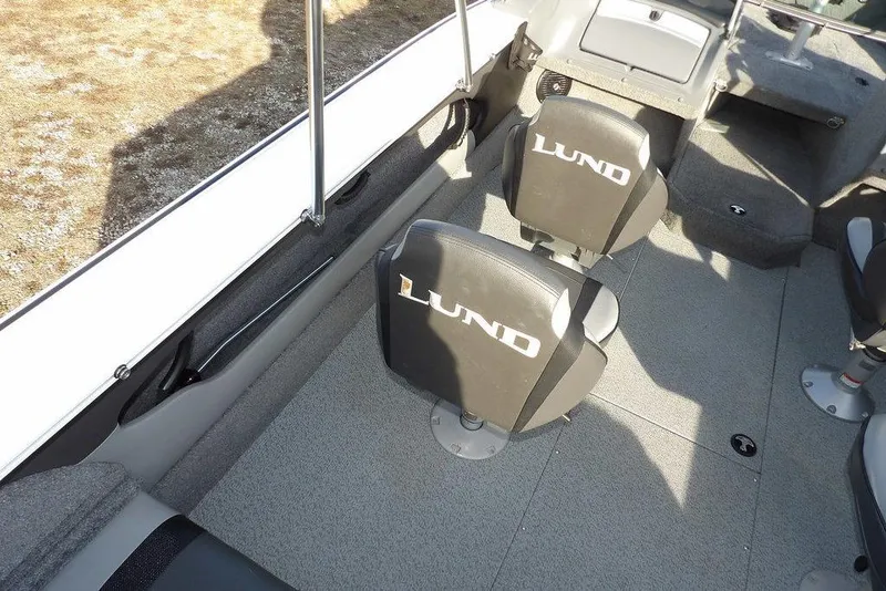Slide: The Image of 2025 Lund 1875 Crossover XS boat interior with branded seats and spacious layout. - 18