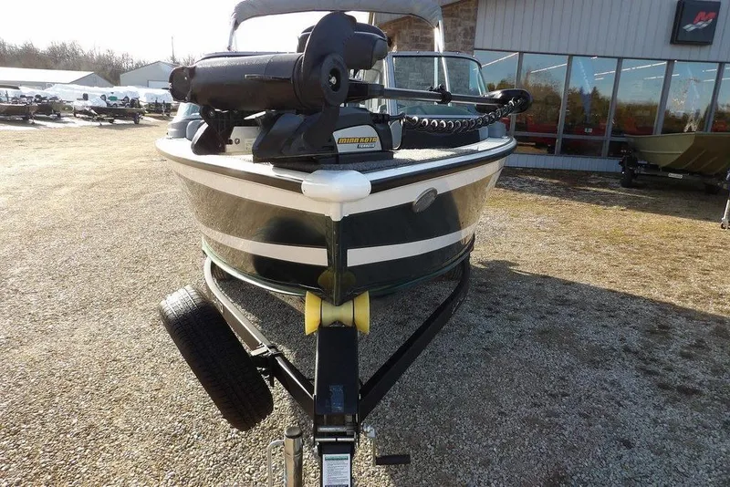 Slide: The Image of 2025 Lund 1875 Crossover XS boat on trailer, outdoor dealership display. - 2