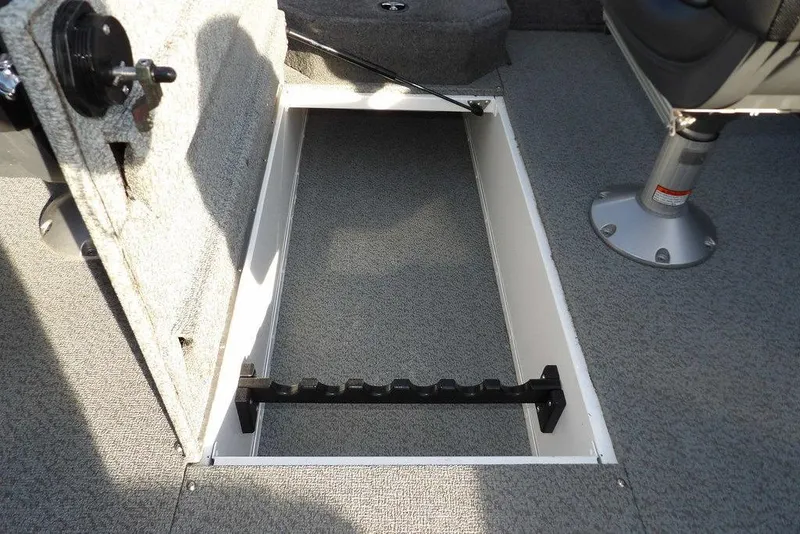 Slide: The Image of 2025 Lund 1875 Crossover XS boat interior with open storage compartment. - 21