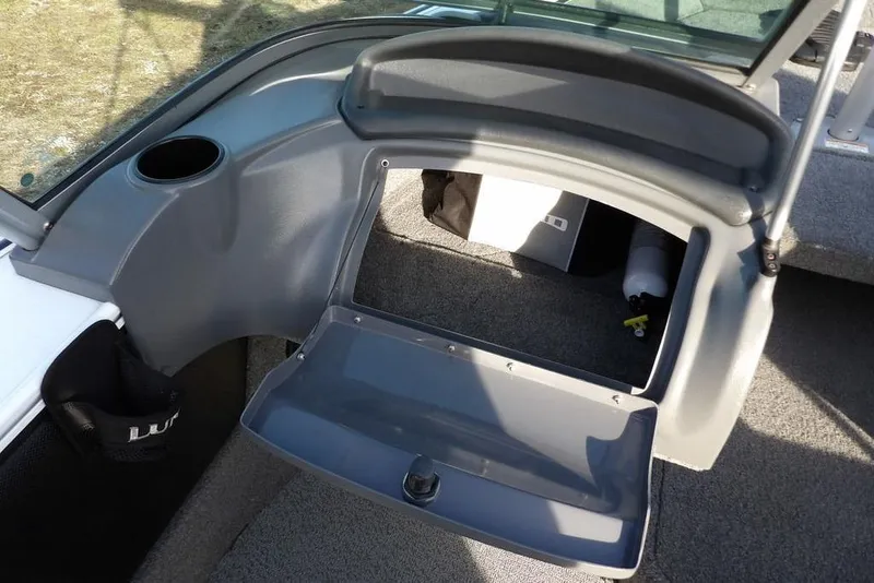 Slide: The Image of 2025 Lund 1875 Crossover XS boat interior storage compartment with open lid. - 22