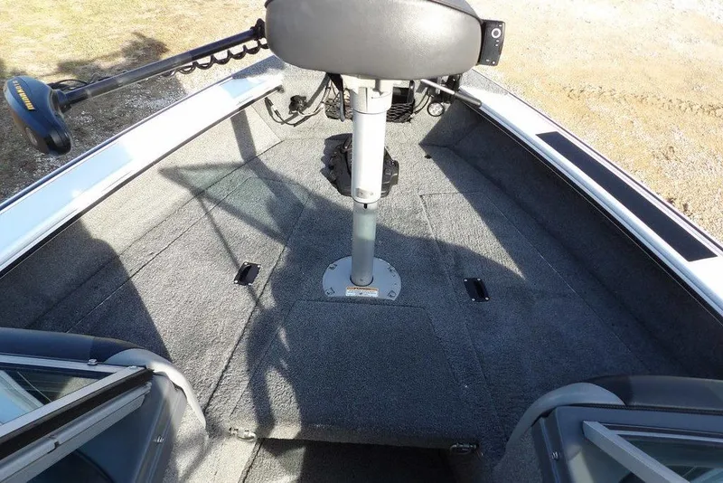 Slide: The Image of 2025 Lund 1875 Crossover XS boat interior with carpeted deck and seating. - 32